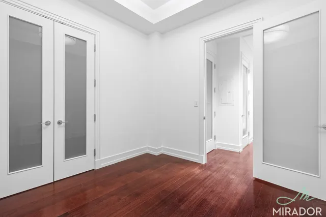 a view of walk in closet with empty racks