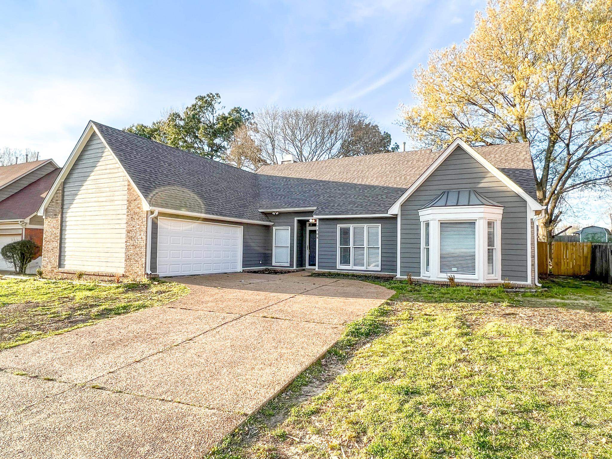 7108 Farmhouse Drive Memphis, TN 38125 - Photo 1 of 21 a front view of a house with garden