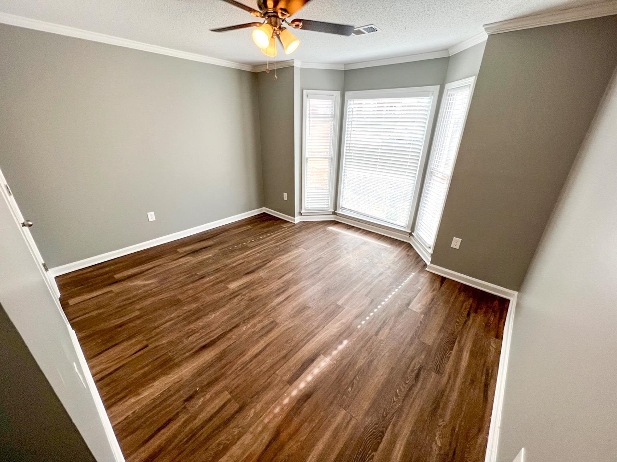7108 Farmhouse Drive Memphis, TN 38125 - Photo 18 of 21 wooden floor in an empty room with a window
