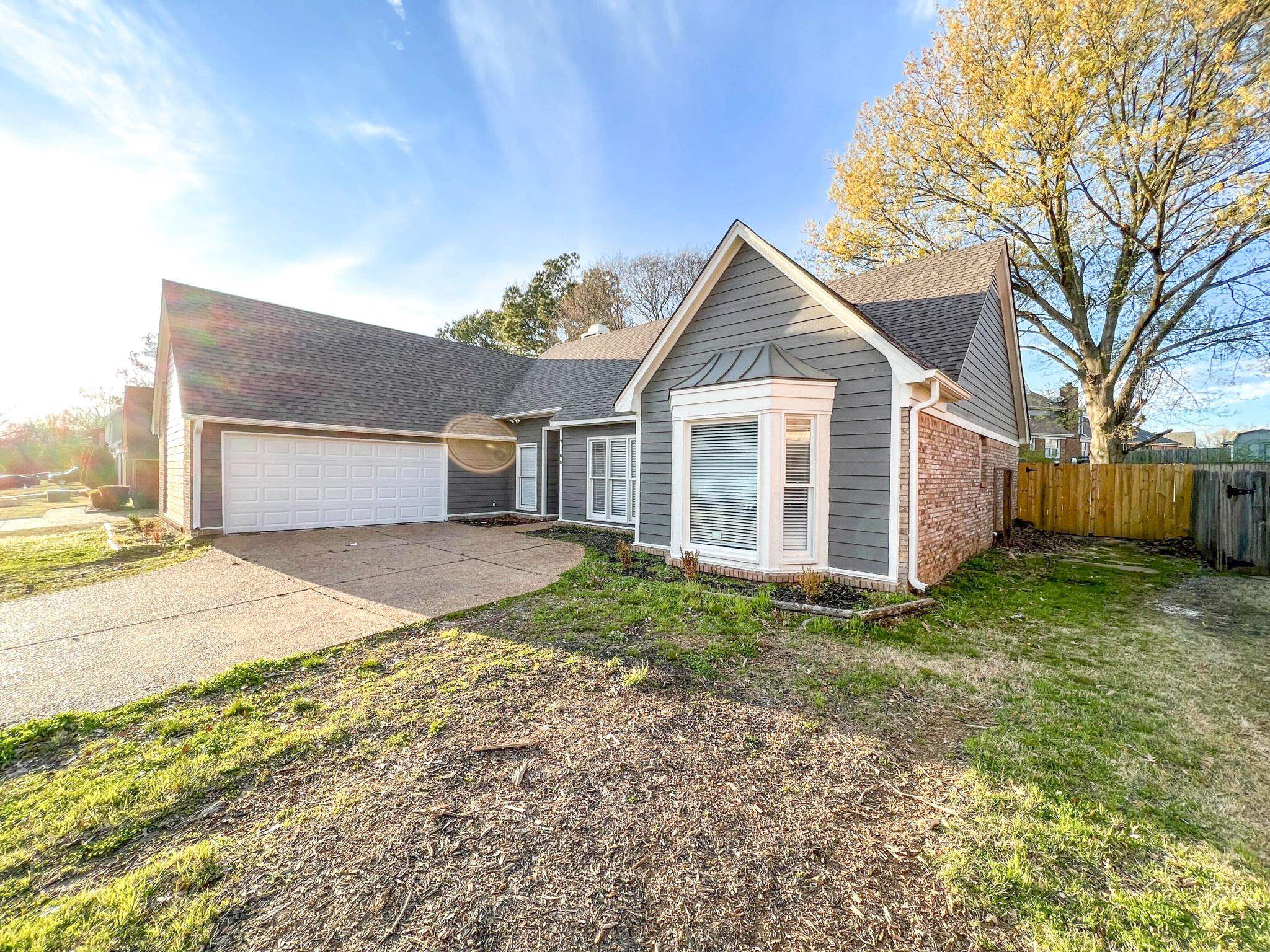 7108 Farmhouse Drive Memphis, TN 38125 - Photo 4 of 21 a view of a yard in front of a house with large trees