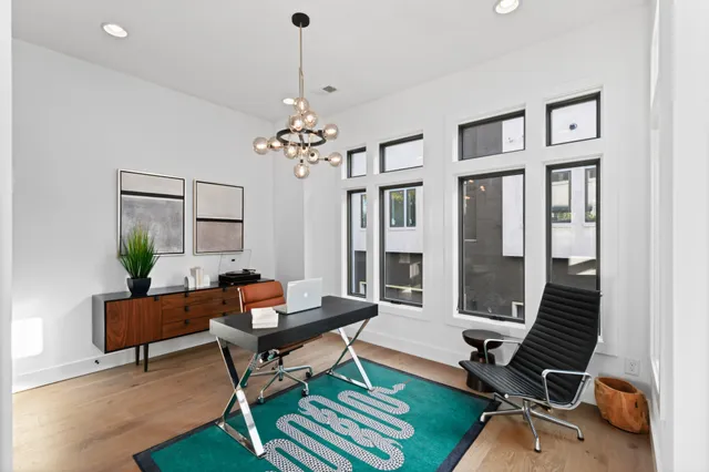 a living room with furniture a piano and a chandelier