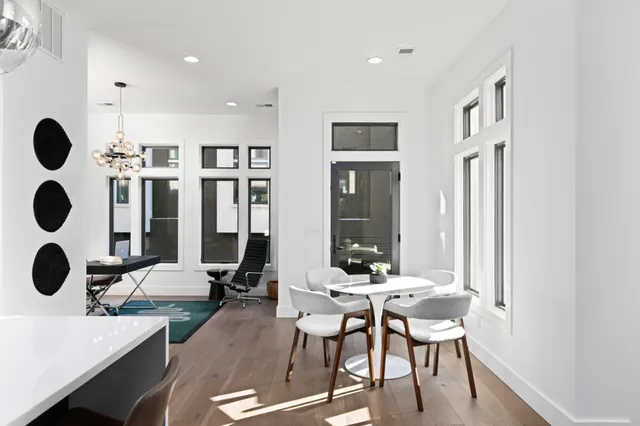 a view of a dining room with furniture and chandelier