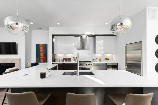 a kitchen with a table chairs stove and refrigerator