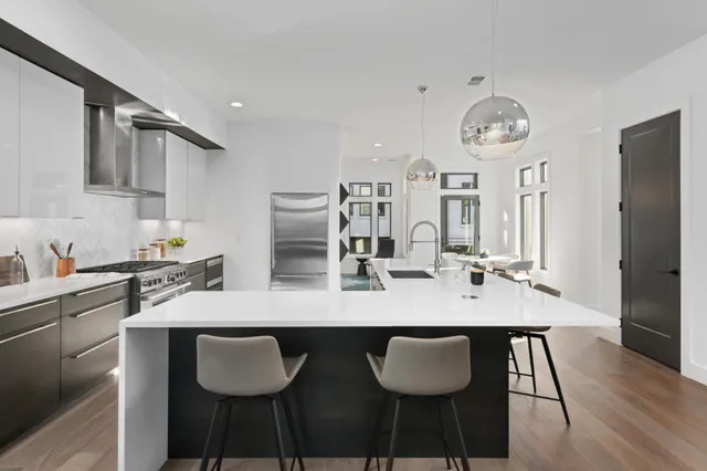 a kitchen with granite countertop kitchen island stainless steel appliances a table and chairs