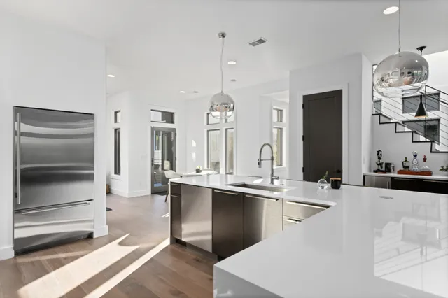 a kitchen with stainless steel appliances a sink stove and refrigerator