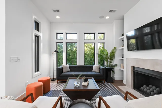 a living room with furniture a fireplace and a flat screen tv