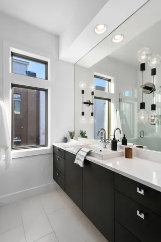a bathroom with a sink double vanity and a mirror