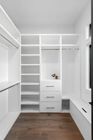 a view of walk in closet with empty racks