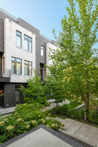 a front view of a house with a yard and trees