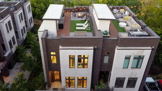 a aerial view of a brick building next to a yard