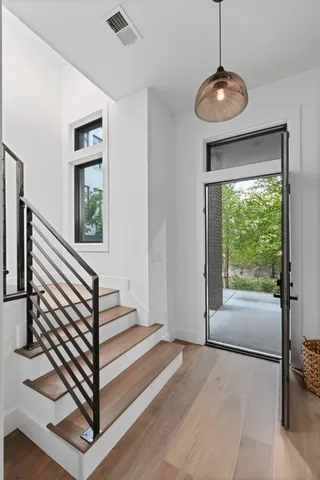 a view of a hallway with window and stairs