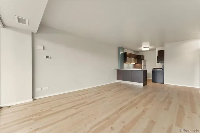 a view of a kitchen with a sink and a refrigerator