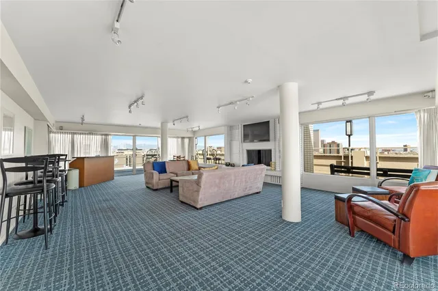 a living room with furniture wooden floor and a table