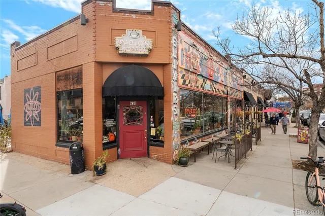 a view of a street with cars parked