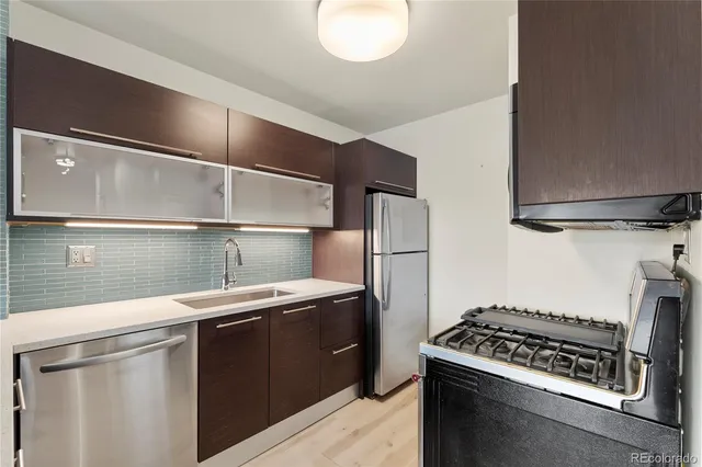 a kitchen with a stove and a refrigerator