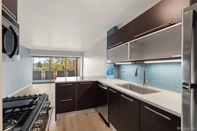 a kitchen that has a sink and a stove