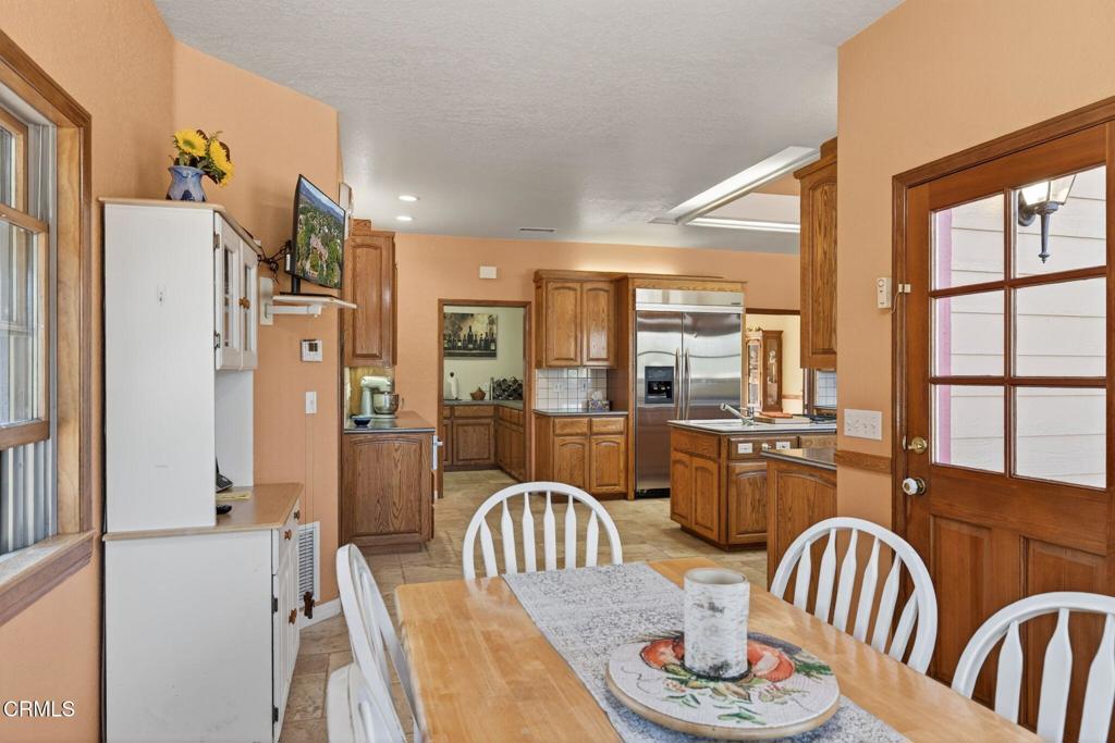 1125 Spring Street Oak View, CA 93022 - Photo 20 of 73 a kitchen with stainless steel appliances granite countertop a dining table and chairs