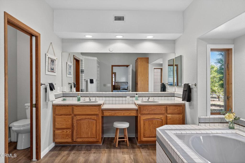 1125 Spring Street Oak View, CA 93022 - Photo 26 of 73 a kitchen with a sink cabinets and wooden floor
