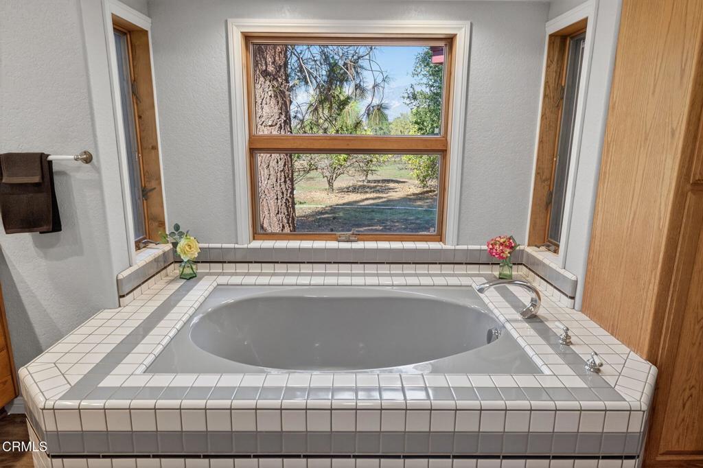 1125 Spring Street Oak View, CA 93022 - Photo 28 of 73 a bathroom with a tub sink and window