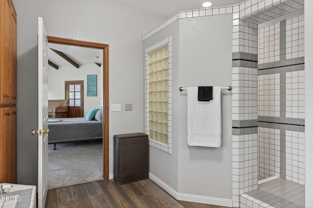1125 Spring Street Oak View, CA 93022 - Photo 29 of 73 a bathroom with a tub a mirror and a shower