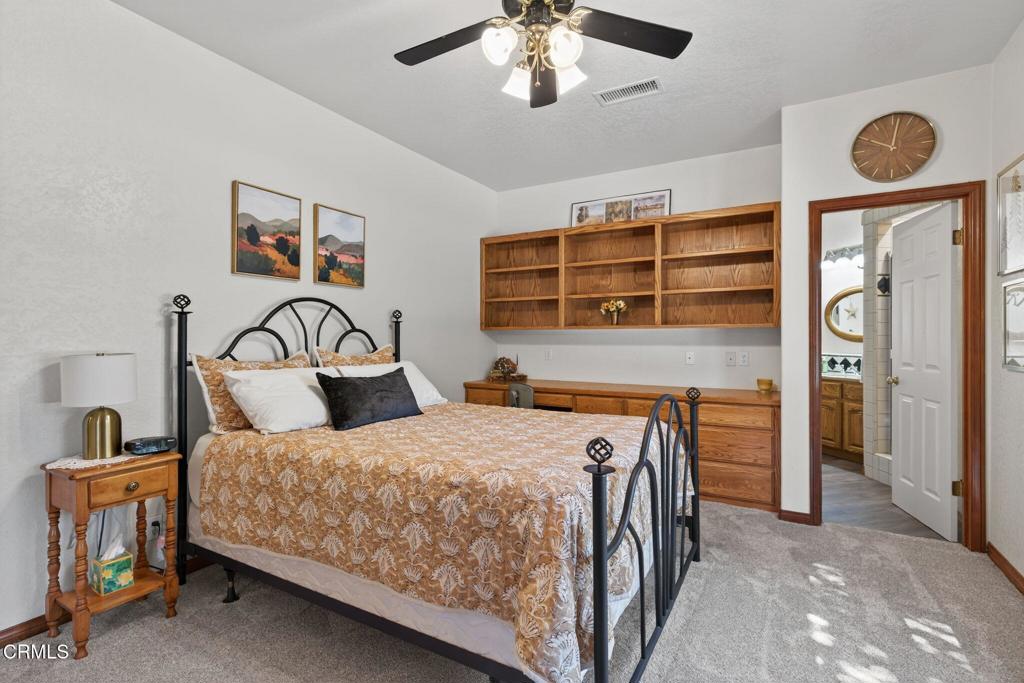 1125 Spring Street Oak View, CA 93022 - Photo 30 of 73 a bedroom with a bed and a chandelier