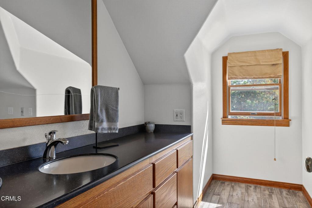1125 Spring Street Oak View, CA 93022 - Photo 42 of 73 a bathroom with a granite countertop sink and a mirror