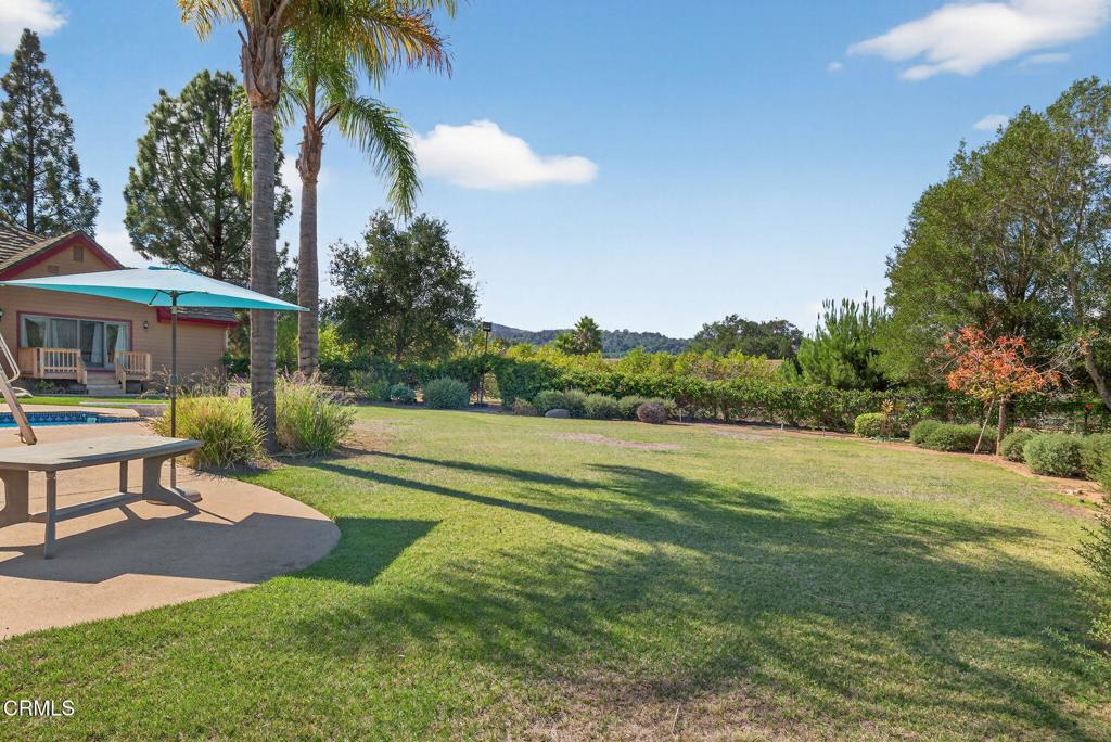 1125 Spring Street Oak View, CA 93022 - Photo 58 of 73 a view of a patio with a table and chairs under an umbrella