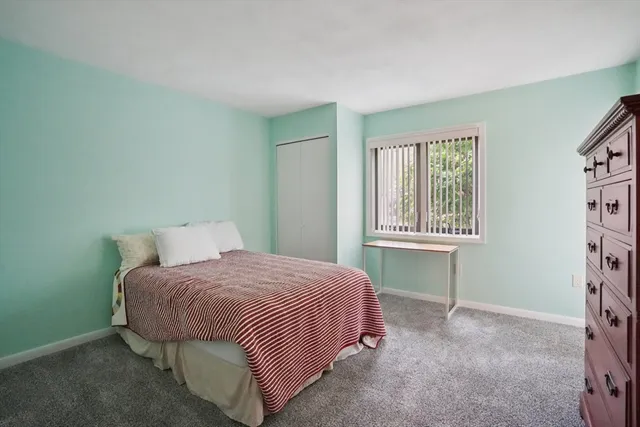 a bedroom with a bed and a table