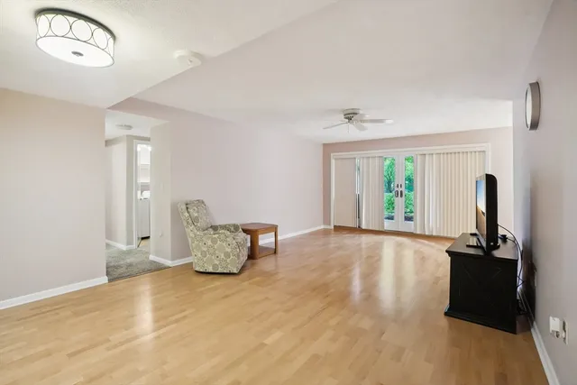 a view of an empty room with wooden floor