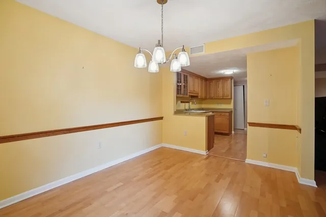 a kitchen with stainless steel appliances granite countertop a sink and dishwasher with white cabinets