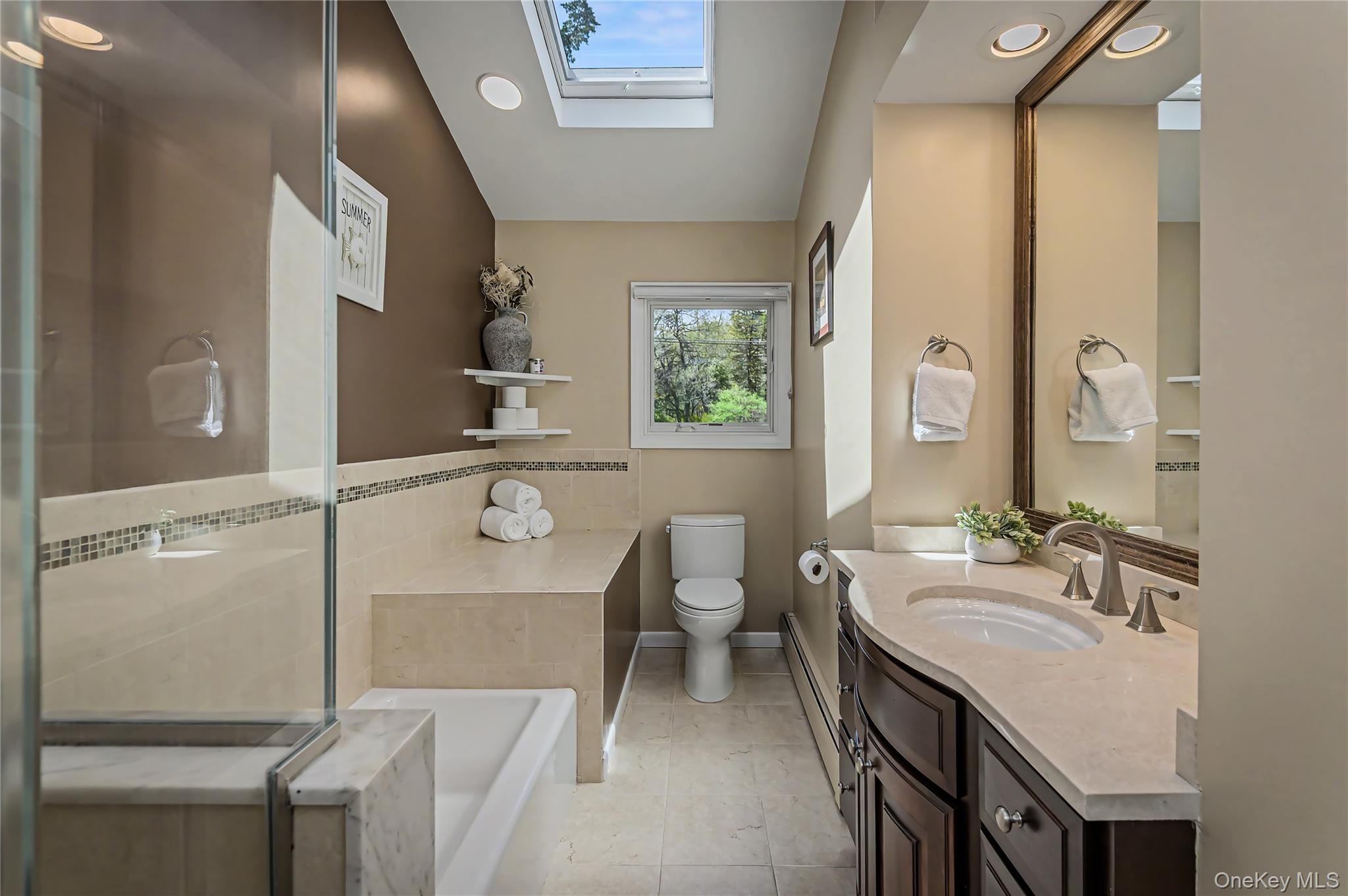 41 Cross Pond Road Pound Ridge, NY 10576 - Photo 23 of 41 a bathroom with a bathtub shower sink and mirror