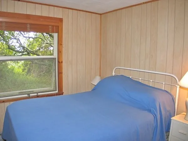 a view of a room with a bed and a window