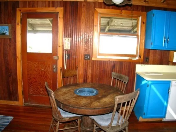 a view of a chairs and table in patio with a fireplace