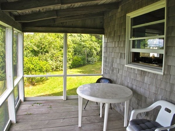 64 Bartimus Luce Road West Tisbury, MA 02568 - Photo 16 of 25 a view of a porch with furniture and a yard