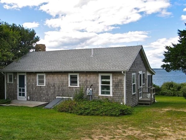 64 Bartimus Luce Road West Tisbury, MA 02568 - Photo 2 of 25 a front view of a house with a garden