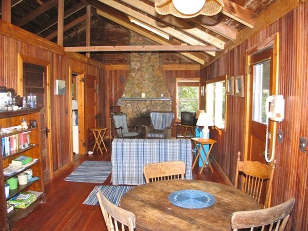 64 Bartimus Luce Road West Tisbury, MA 02568 - Photo 5 of 25 a dining room with furniture a chandelier and wooden floor