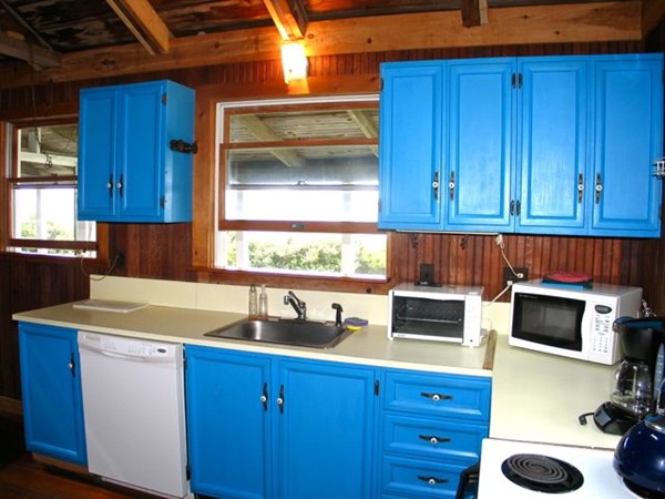 64 Bartimus Luce Road West Tisbury, MA 02568 - Photo 9 of 25 a kitchen with a cabinets and a stove top oven