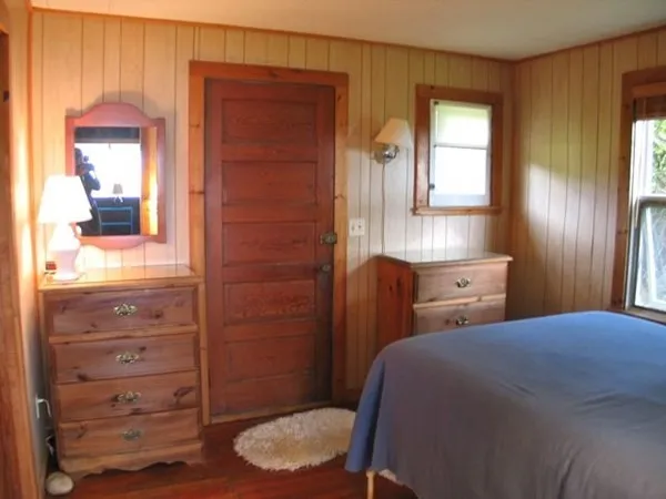 a bedroom with a bed and a dresser