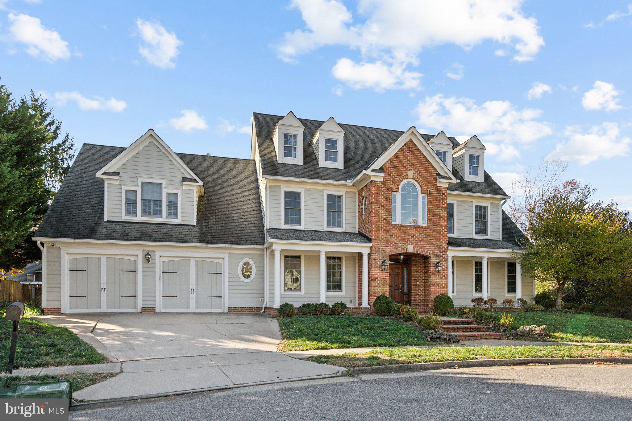 8802 Northern Spruce Lane Alexandria, VA 22309 - Photo 2 of 41 a front view of a house with a garden and trees