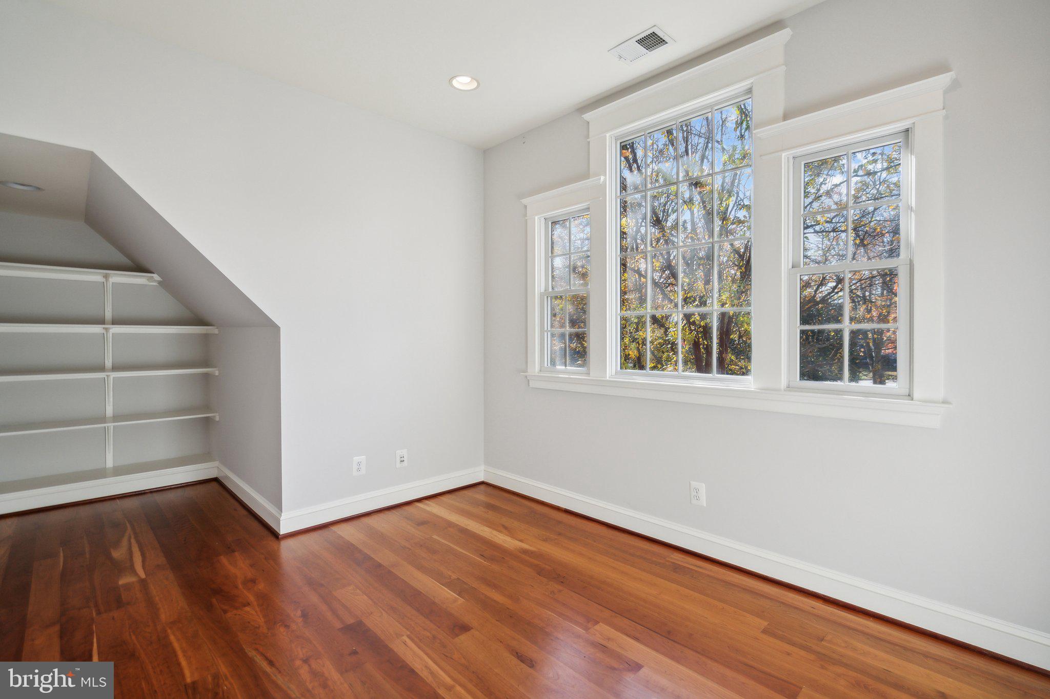8802 Northern Spruce Lane Alexandria, VA 22309 - Photo 23 of 41 a view of an empty room with wooden floor and a window