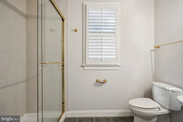 a bathroom with a toilet and a shower