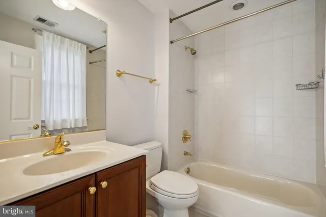 a bathroom with a sink toilet vanity and shower