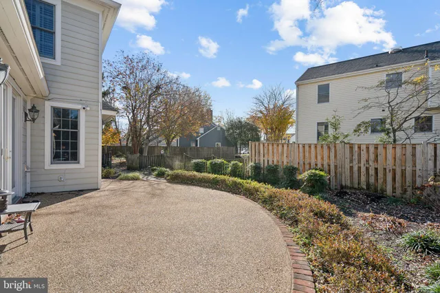 a view of a house with a small yard and wooden fence
