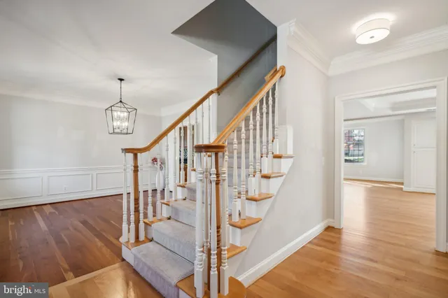 a view of entryway and hall with wooden floor