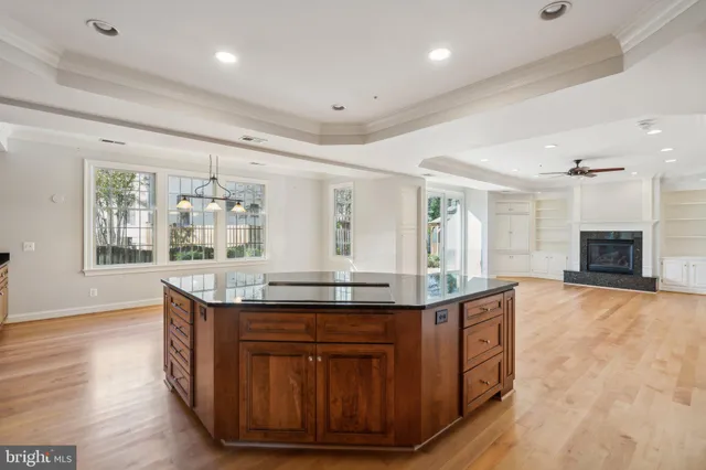 a kitchen with granite countertop a stove and a wooden floors