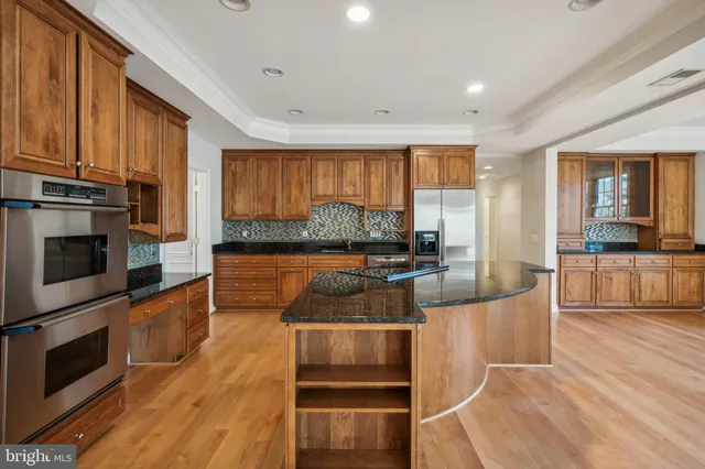 a kitchen with granite countertop a stove and cabinets