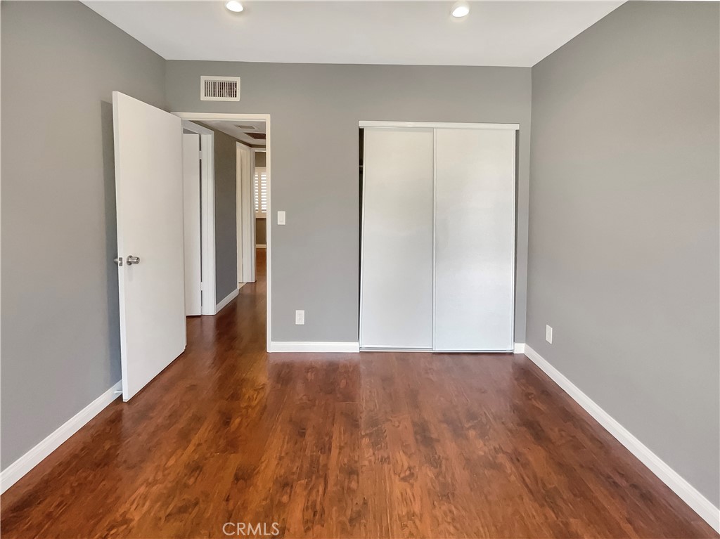 14560 Clark Street, Unit 202 Sherman Oaks, CA 91411 - Photo 14 of 18 a view of an empty room with wooden floor and closet