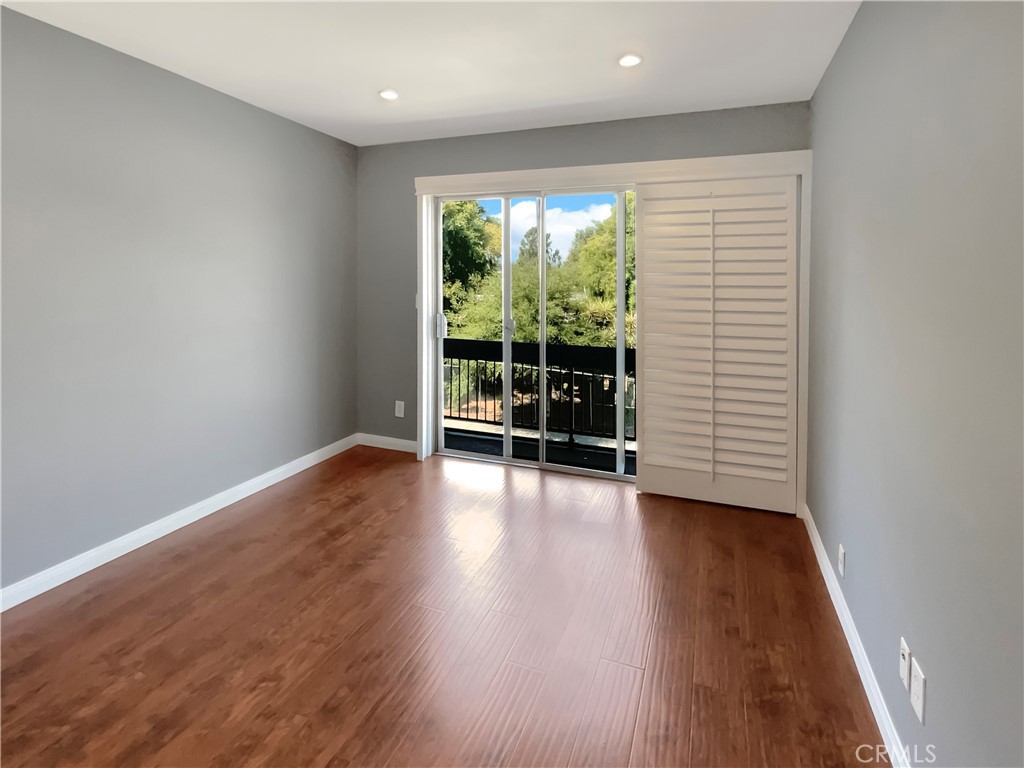 14560 Clark Street, Unit 202 Sherman Oaks, CA 91411 - Photo 17 of 18 wooden floor in an empty room with a window