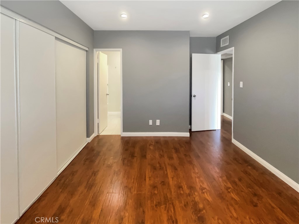 14560 Clark Street, Unit 202 Sherman Oaks, CA 91411 - Photo 9 of 18 a view of an empty room with wooden floor