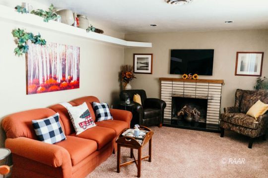 428 Peg Street Ridgecrest, CA 93555 - Photo 7 of 29 a living room with furniture a flat screen tv and a fireplace